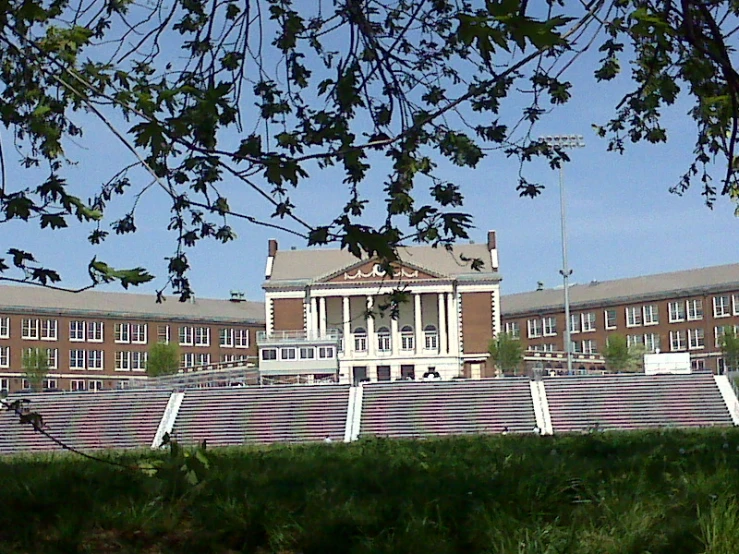 a building with steps, a gate and green grass