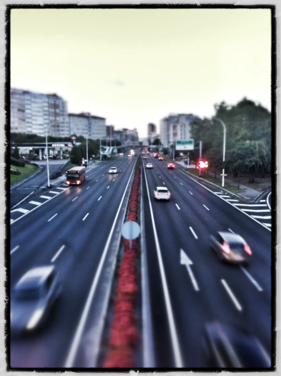 a traffic scene with blurry cars driving along