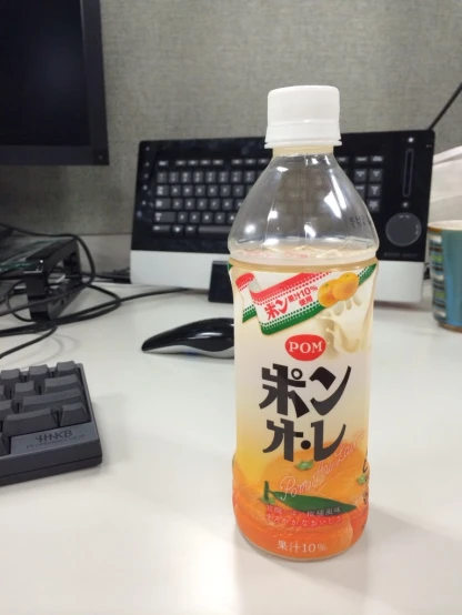 a bottle of juice is sitting on a desk