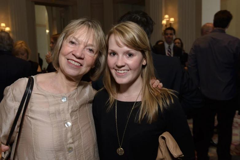 two women smiling with their arms around one another