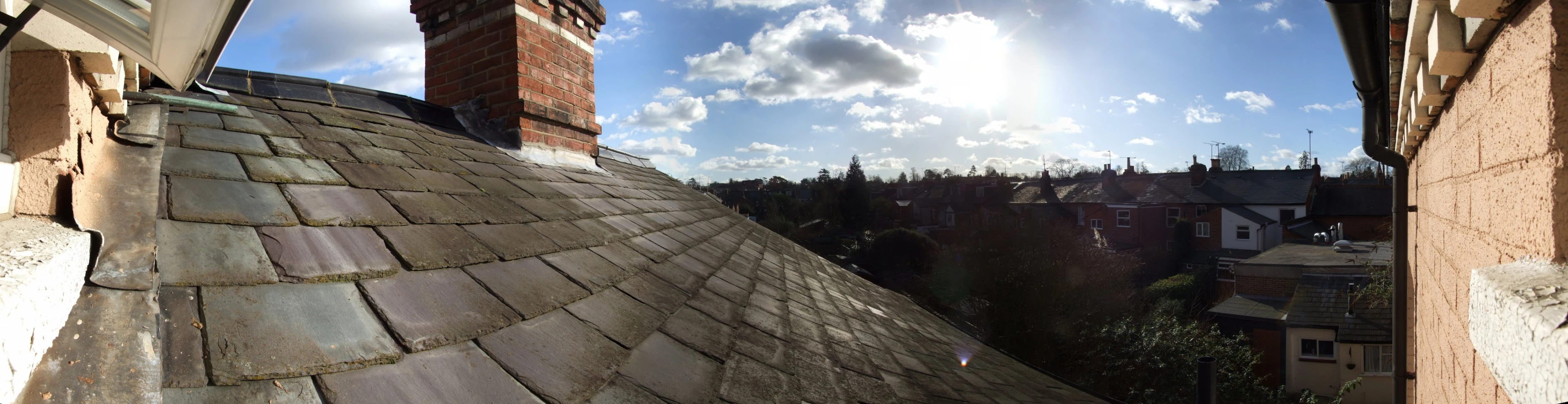 a beautiful sun shining over some building roof tops