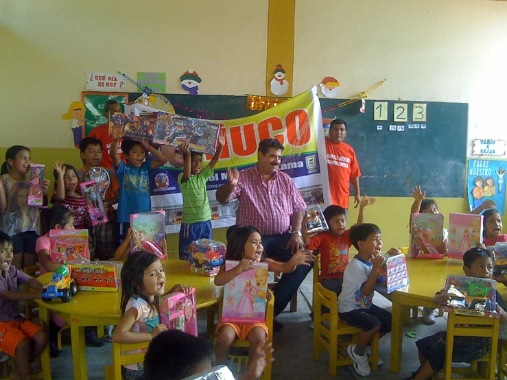 people are shown in a classroom with children holding up signs