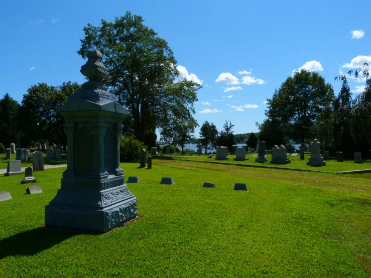 a cemetery with many headstones and crosses in the grass