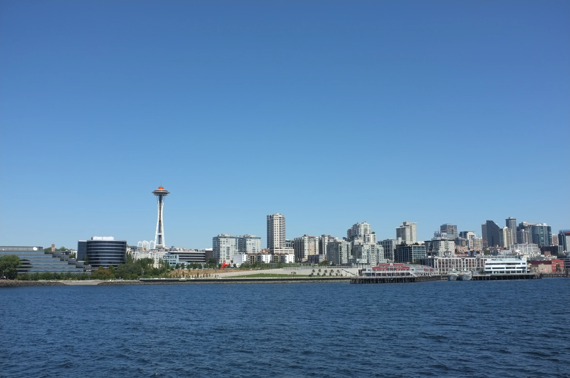 the city skyline is behind a body of water