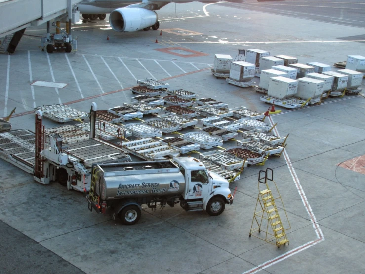 a truck parked next to a white plane