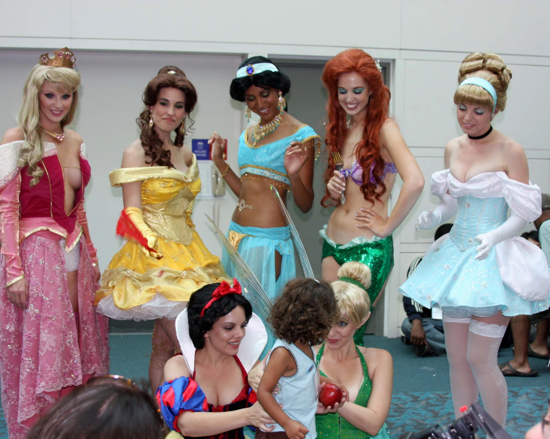 the four women are wearing princess dresses and posing for pos