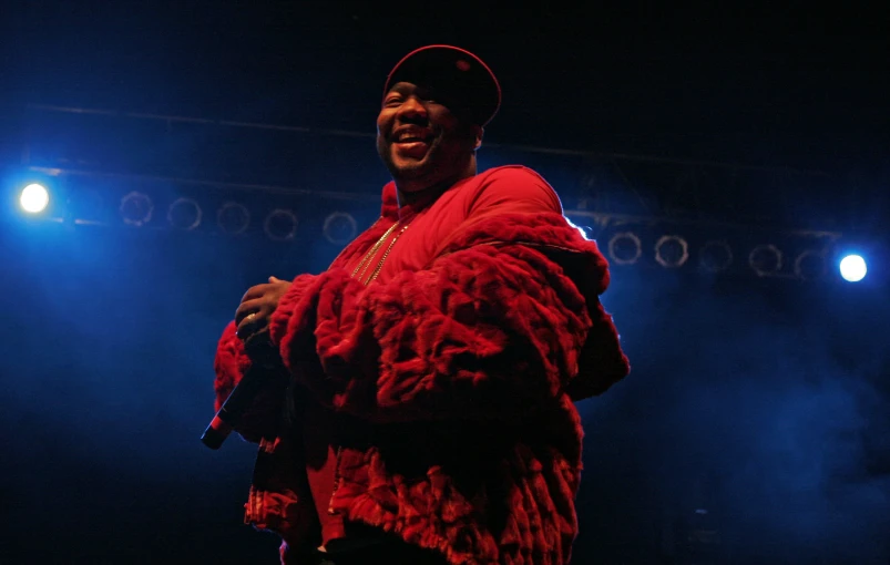 a man is singing and smiling at the concert