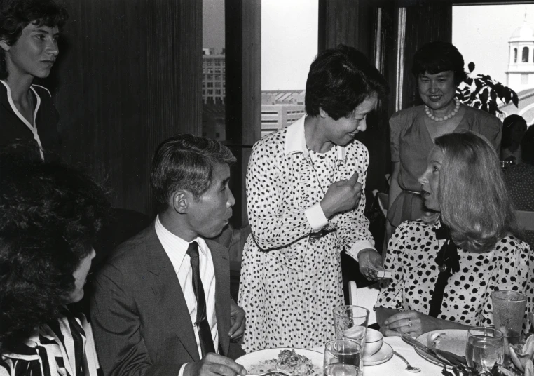 several people are gathered around a table to have lunch