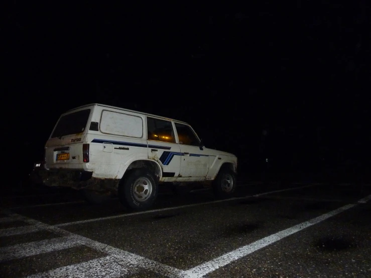 a vehicle parked at an intersection in the dark