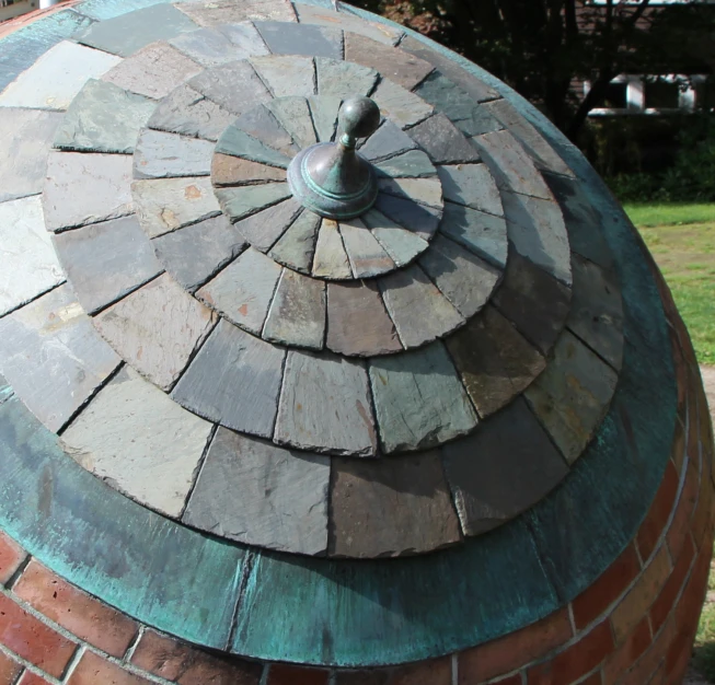 a colorful clock surrounded by multi colored brick