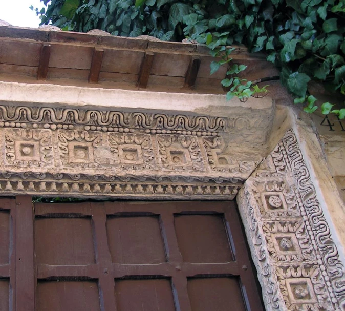 an elaborately decorated entry with green foliage on the wall