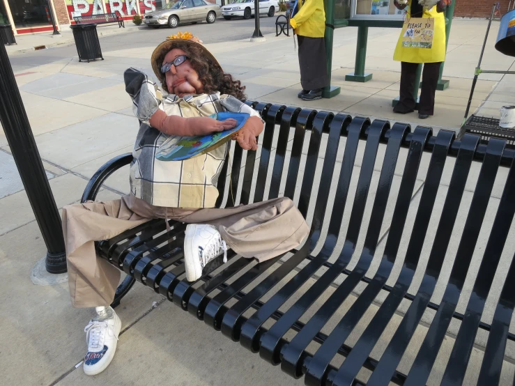 a statue of a person in an outfit sitting on a bench