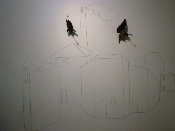 two birds are flying near each other on the white wall