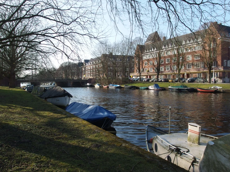 a group of small boats floating down a canal