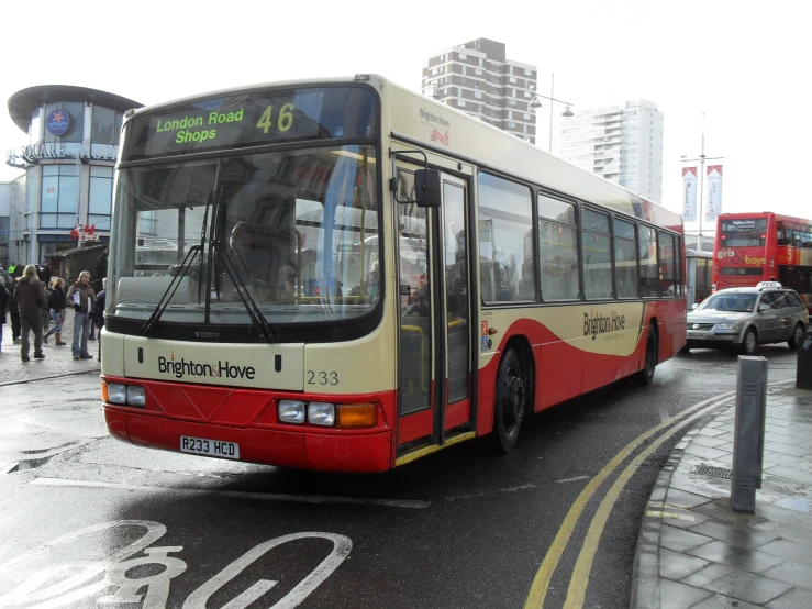 a bus drives down a road on a rainy day