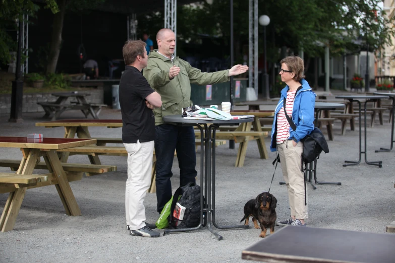 people are standing at a table and having tea