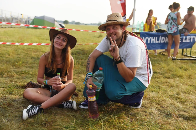 a couple of people that are sitting in the grass