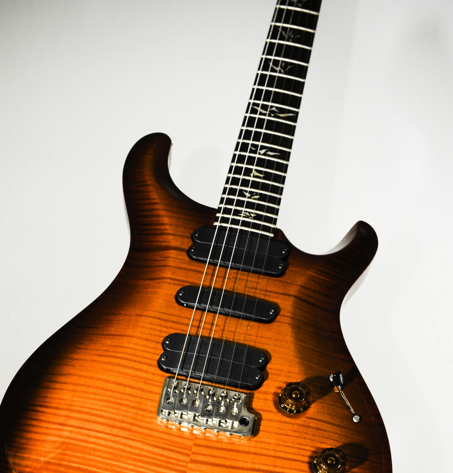 a brown electric guitar sitting on top of a table