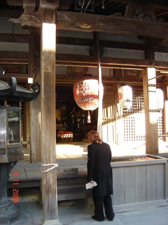 a man in suit standing near a building