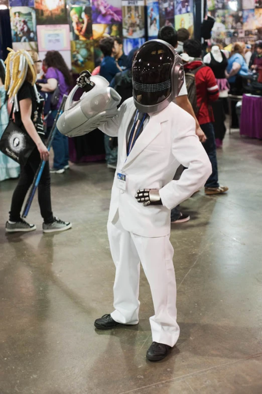 man wearing suit and tie posing in front of crowd