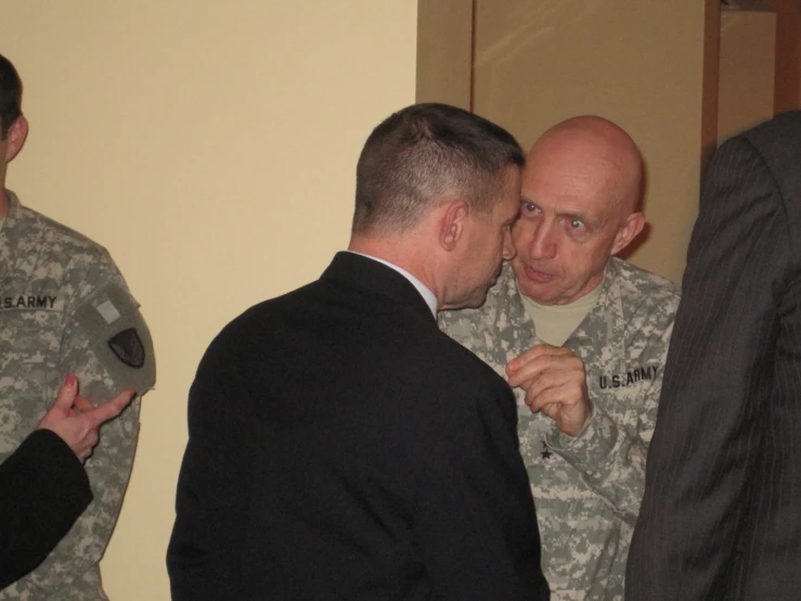 military men having a conversation while standing next to each other