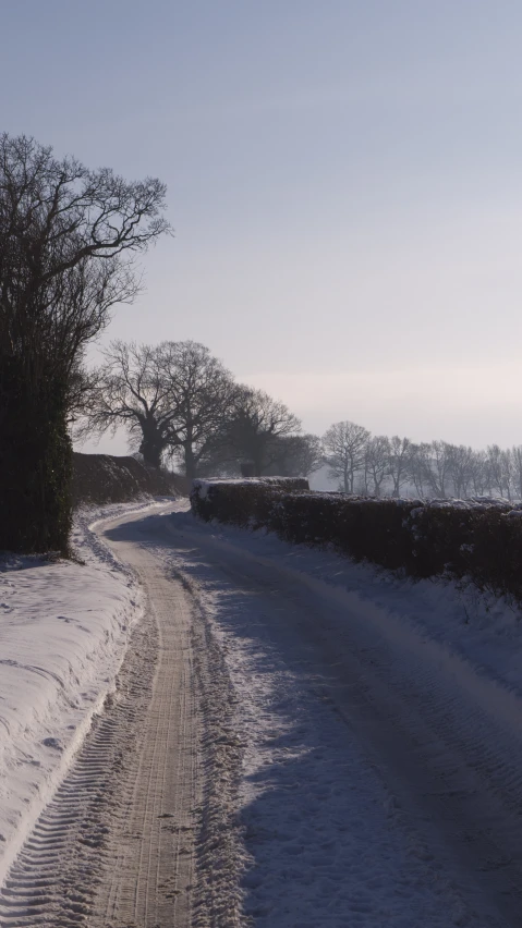 a snowy road and a truck on it