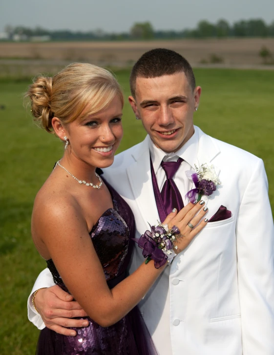 a couple poses for a picture while wearing wedding jewelry