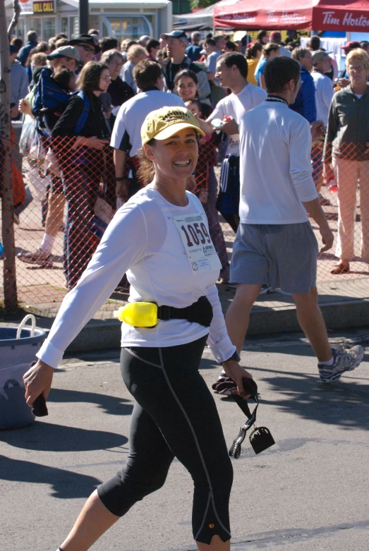 a woman in a hat and cap playing tennis