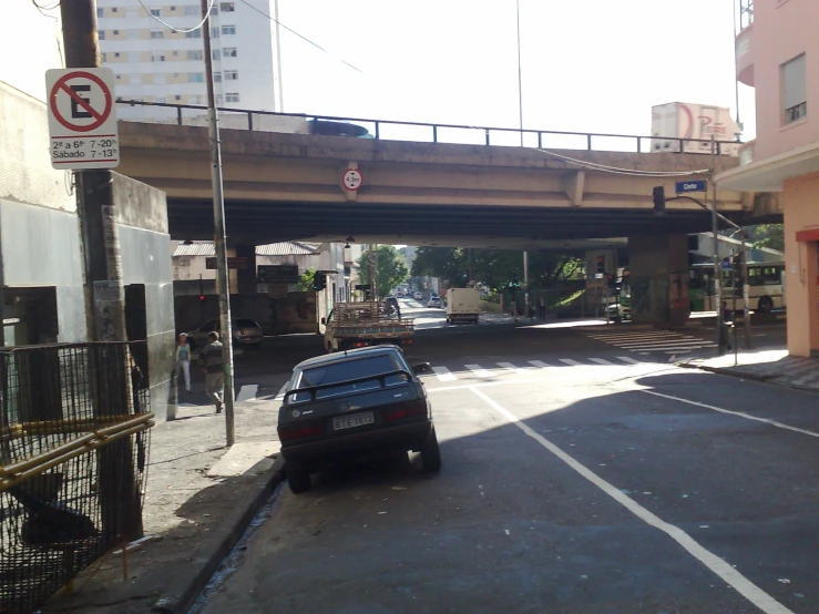 a car is driving under a bridge on the road