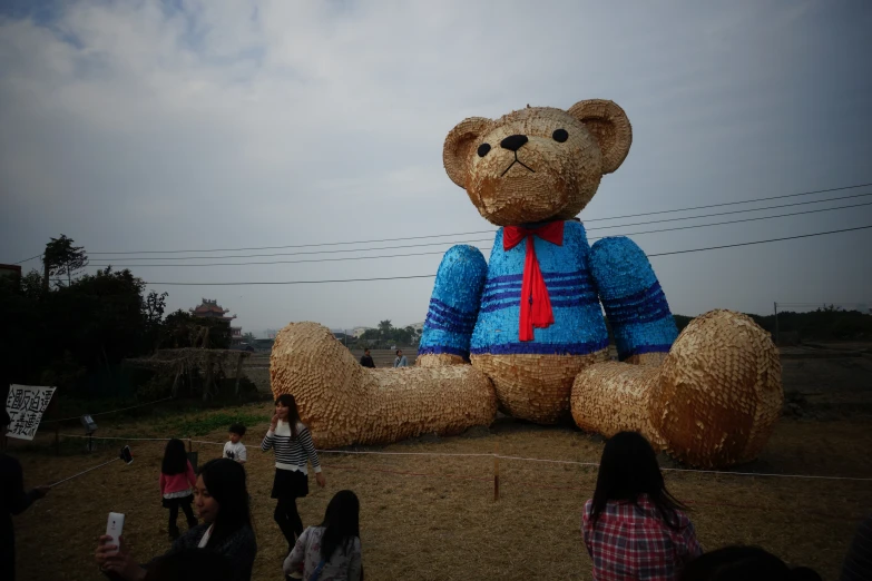 a teddy bear balloon with a red tie on