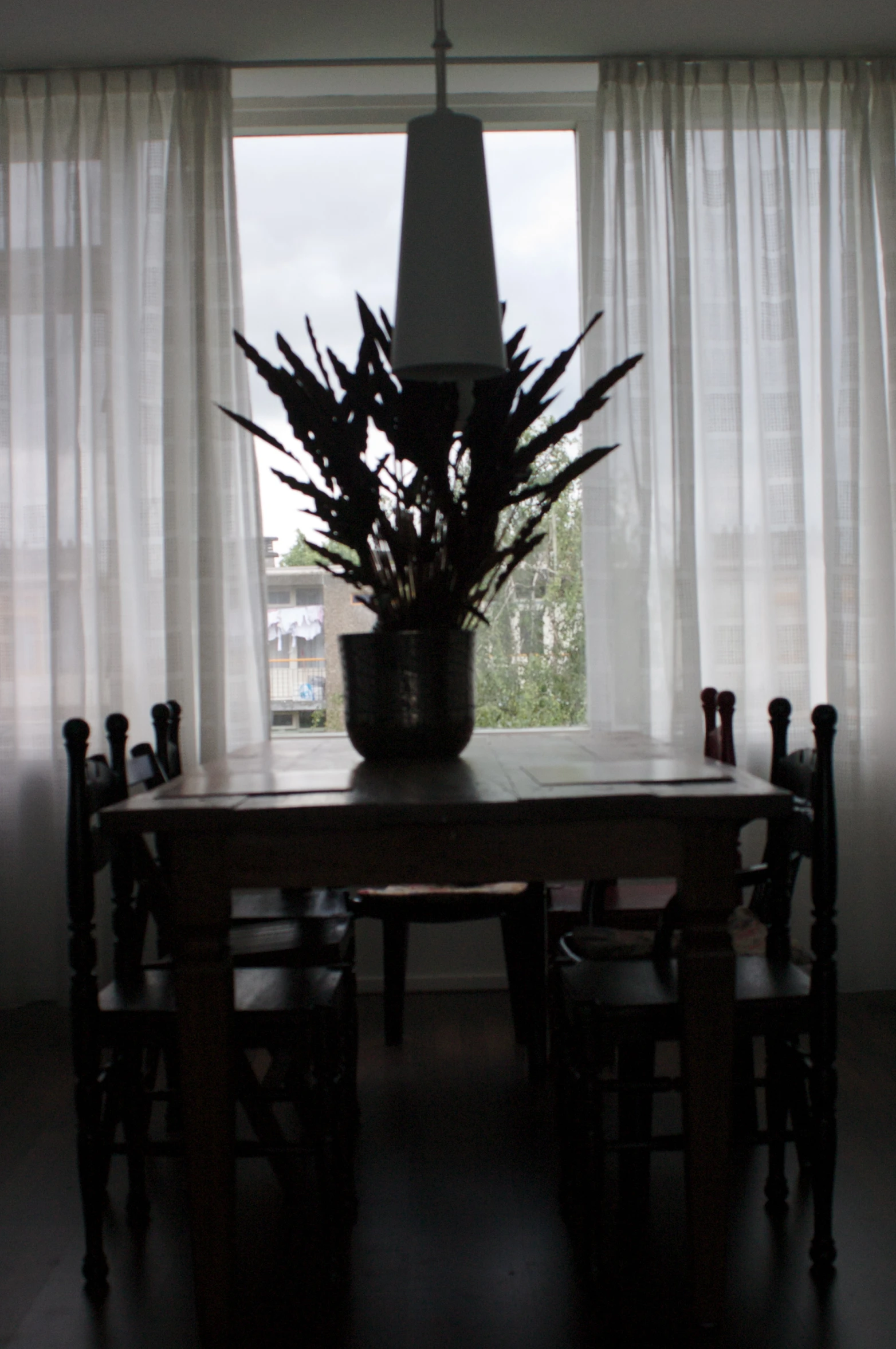 a vase on top of a table next to chairs