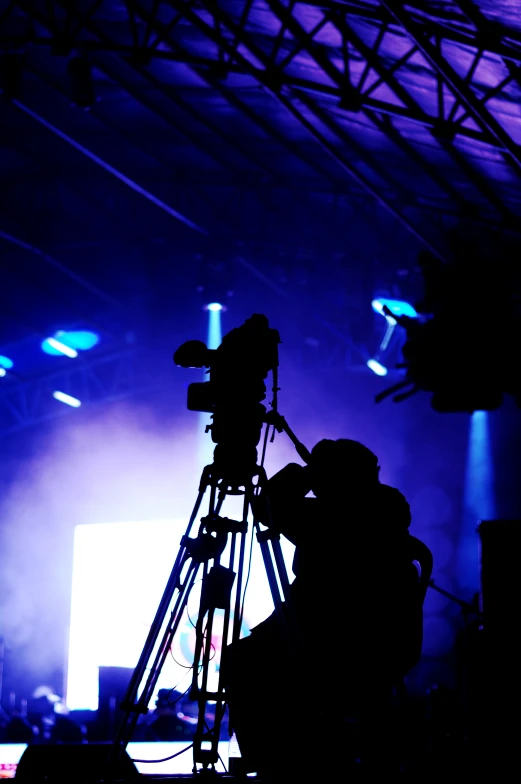 several pographers recording a stage lights event