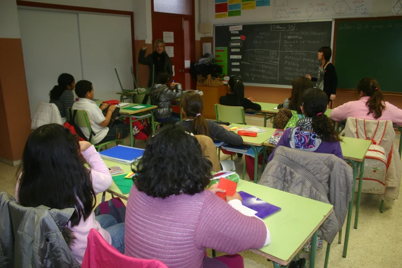 a teacher giving a class to students at desks