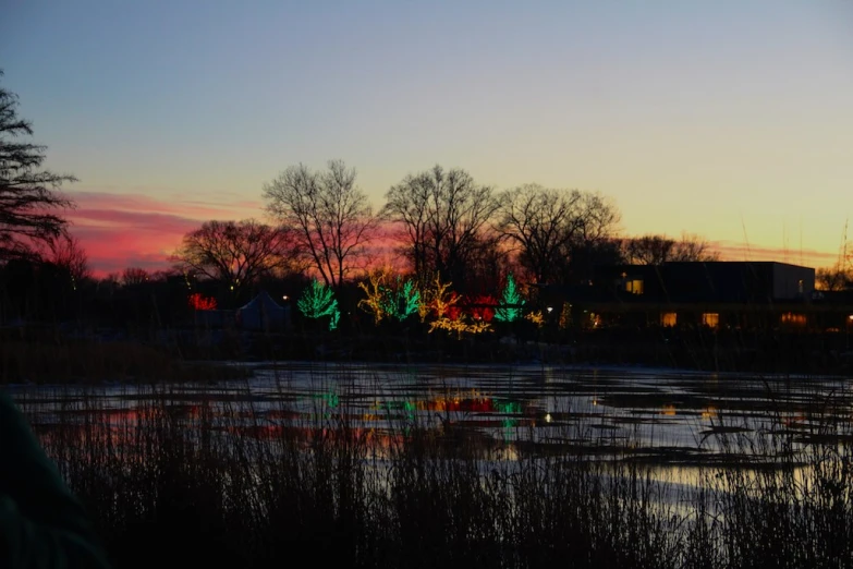 a lake and city lights lit up in the sky