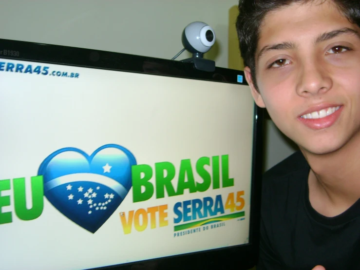 a young man is holding up a tv screen