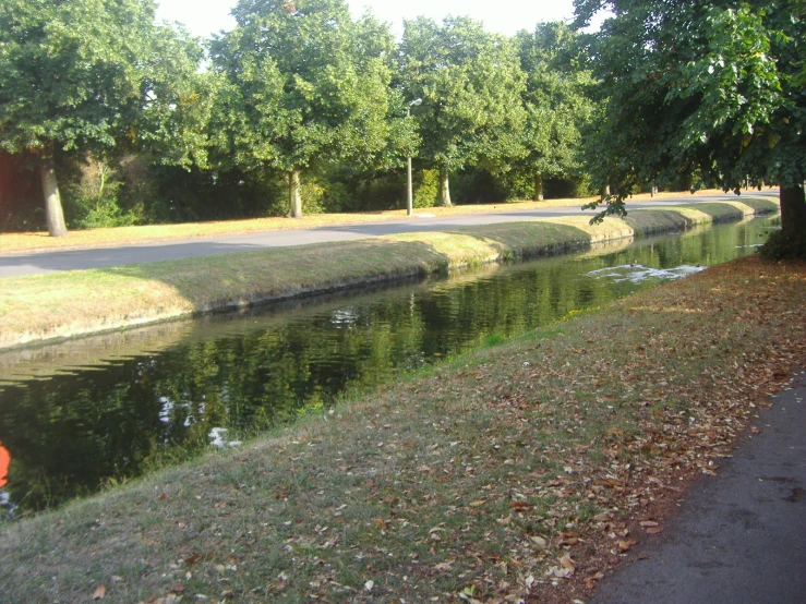 this is a road near the edge of a canal