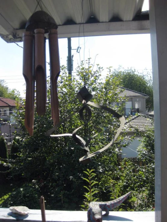 a metal bird sculpture sitting on top of a roof