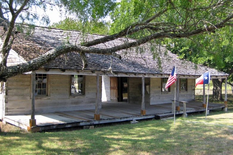 an old, run down building with wood floors and a flag