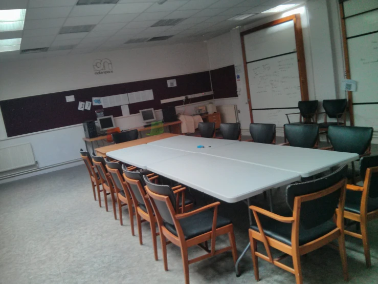 a conference room is shown with many chairs and a table