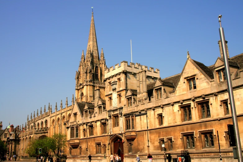 a building in the middle of a large area with people walking in the front