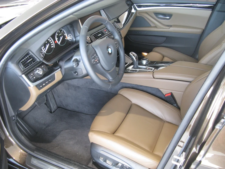 interior of vehicle with leather and controls, dashboard and tan seats