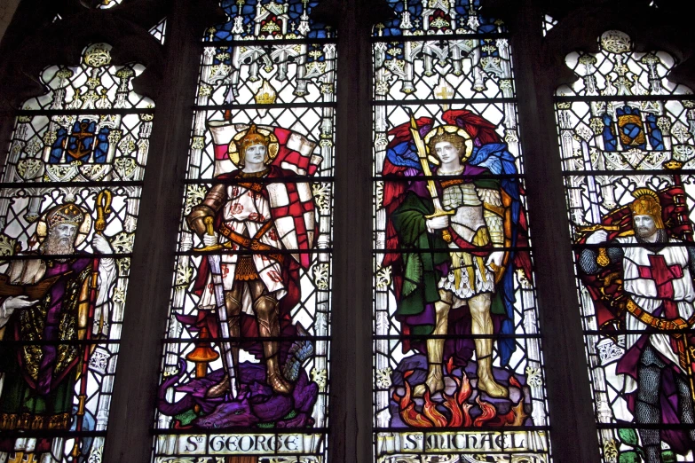 a large stain glass window with many paintings of people