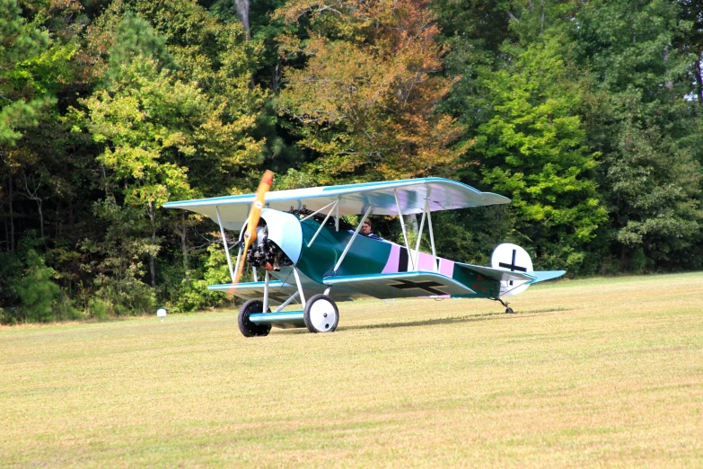 an old style airplane is parked in the middle of the field