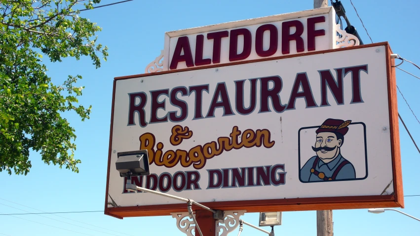 a restaurant sign with a cartoon of a man on the sign