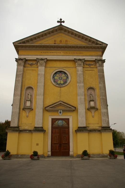 the yellow building has columns and windows