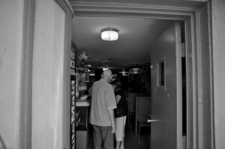 two people are walking down an office hallway