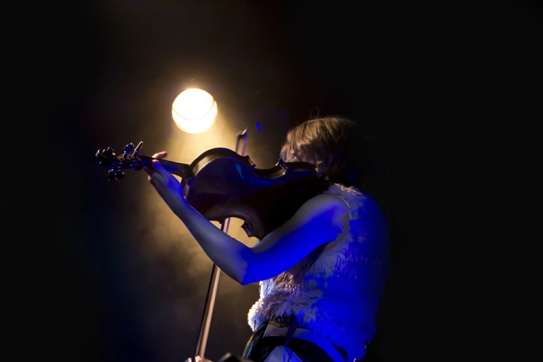 a woman holding a violin in her hands