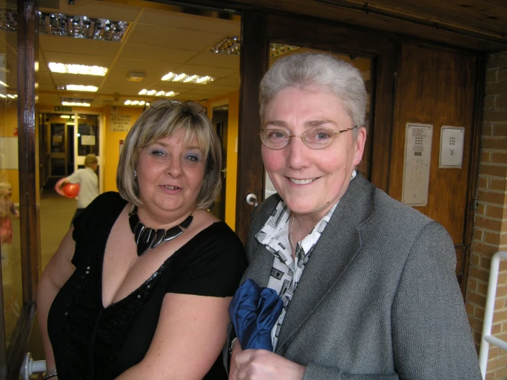 an older woman poses for a po with a younger woman