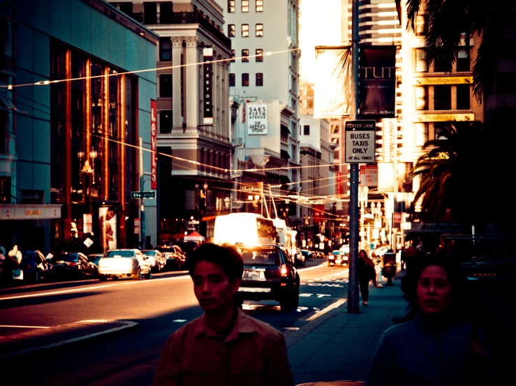 a man and a woman walking down the street in a city at night