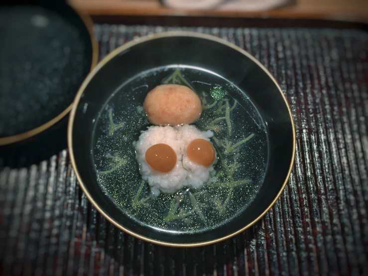 a black plate topped with eggs on top of a bamboo mat